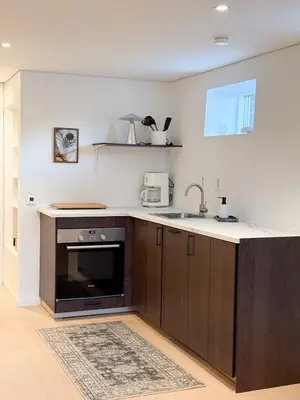 a kitchen with a sink and a counter top at Soft Stay Apartment in Bergen