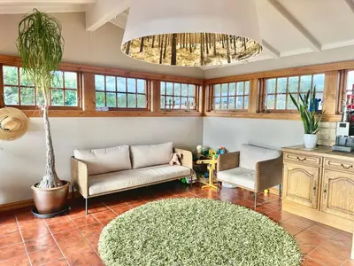 a living room with a couch and a table at Hilltop Panorama view retreat in Ålesund