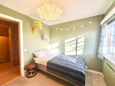 a bedroom with a bed and a window at Hilltop Panorama view retreat in Ålesund