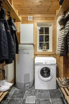 a laundry room with a washing machine and a washer at Charming cabin in Hemsedal Golf Alpin - ideal for families, fishing & skiing in Hemsedal