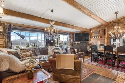 a living room filled with furniture and a chandelier at Trysilfjell hytteomrade 587 by Vacation Trysil in Hovi