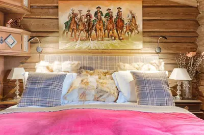 a bedroom with a bed with a painting on the wall at Trysilfjell hytteomrade 587 by Vacation Trysil in Hovi