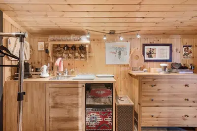 a kitchen with wooden cabinets and a sink in a room at Trysilfjell hytteomrade 587 by Vacation Trysil in Hovi