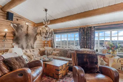 a living room with leather furniture and a chandelier at Trysilfjell hytteomrade 587 by Vacation Trysil in Hovi