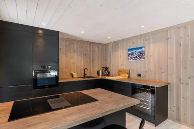 a kitchen with wooden walls and a wooden counter top at Trysilfjell hytteomrade 2124 by Vacation Trysil in Hovi