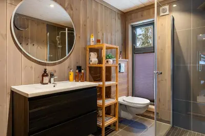 a bathroom with a sink and a toilet and a mirror at Trysilfjell hytteomrade 2124 by Vacation Trysil in Hovi