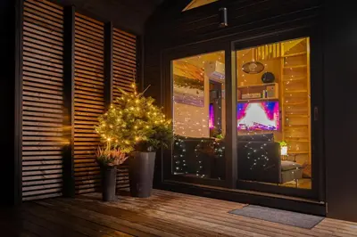 a room with a window with a christmas tree in it at Unique Nature Hideaway Close to Norefjell