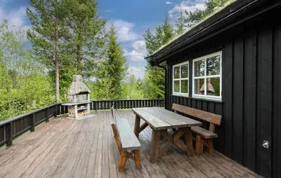 a wooden deck with a picnic table and a grill at 3 Bedroom Gorgeous Home In Nesbyen in Nesbyen