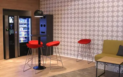 a room with red stools in front of a wall at Trudvang Apartment Hotel in Rena