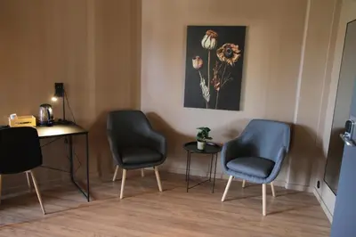 a waiting room with two chairs and a table at Trudvang Apartment Hotel in Rena