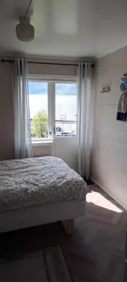 a bedroom with a bed and a large window at Grodås Lake View Apartment in Hornindal