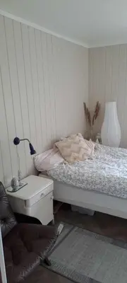a bedroom with a bed and a table with a lamp at Grodås Lake View Apartment in Hornindal
