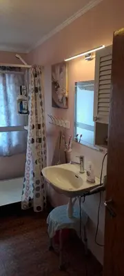 a bathroom with a sink and a tub and a window at Grodås Lake View Apartment in Hornindal