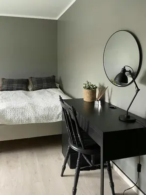 a bedroom with a desk with a bed and a lamp at Modern Cottage With River Frontage Near Opphus in Rena