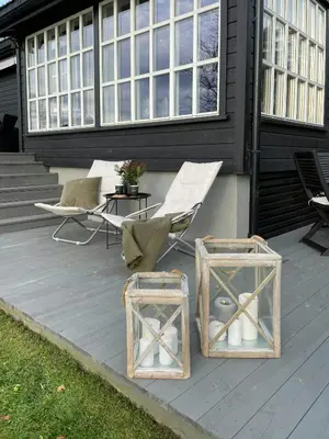two chairs and a table on a patio at Modern Cottage With River Frontage Near Opphus in Rena