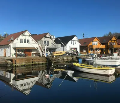 a couple of boats are docked at a marina at Fishermen's Cabin With Sea View in Bømlo