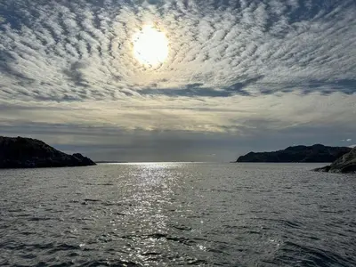 a large body of water with a cloudy sky at Fishermen's Cabin With Sea View in Bømlo