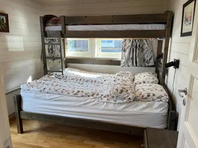 a bed in a room with a bunk bed at TexasToppen, cabin in Hafjell with sauna in Hafjell