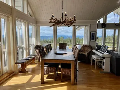 a living room with a table and chairs and a couch at TexasToppen, cabin in Hafjell with sauna in Hafjell