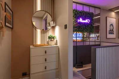 a dressing room with a mirror and a dresser at Nordic Nook - Modern downtown apartment in Ålesund