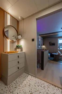 a kitchen with a dresser and a living room at Nordic Nook - Modern downtown apartment in Ålesund