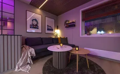 a living room with a couch and a table at Nordic Nook - Modern downtown apartment in Ålesund