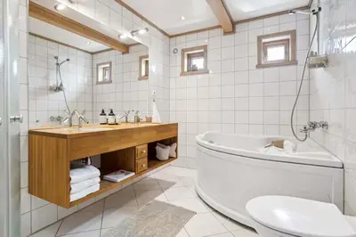 a bathroom with a tub and a toilet and a sink at RVH29 - Fjord Hideaway Villa in Veland