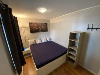a small room with a bed and a shelf at 5 person holiday home in Flatanger in Vik