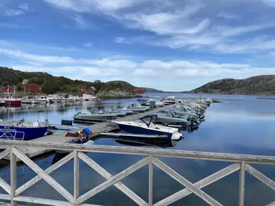 a group of boats docked at a dock in the water at 5 person holiday home in Flatanger in Vik