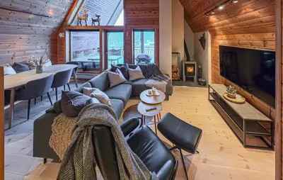 a living room with a couch and a large tv at Beautiful Apartment In Bjorli With Sauna in Bjorli