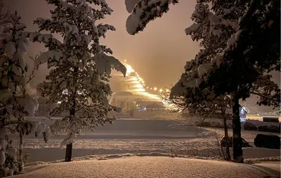 a snow covered street with a building in the distance at Beautiful Apartment In Bjorli With Sauna in Bjorli