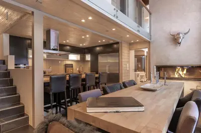 a dining room and kitchen with a table and chairs at Fjellspa med Fantastisk utsikt og Høy standard in Aurdal