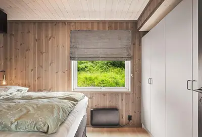 a bedroom with a bed and a window at Exclusive and Uniqe Apartment - Ski in ski out! in Vossevangen