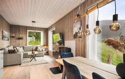 a living room with a table and a couch at Exclusive and Uniqe Apartment - Ski in ski out! in Vossevangen