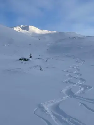 a snow covered mountain with footprints in the snow at Hemsedal, Ski-in ski-out, Skarsnuten Panorama in Hemsedal