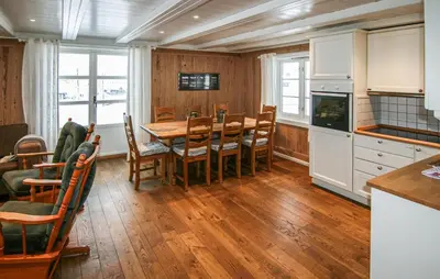 a kitchen and dining room with a table and chairs at Lovely Home In Sjusjøen With Sauna in Sjusjøen