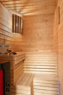 a sauna with wooden walls and a wooden floor at Bekkeblom, family cabin with extension in Hafjell in Hafjell