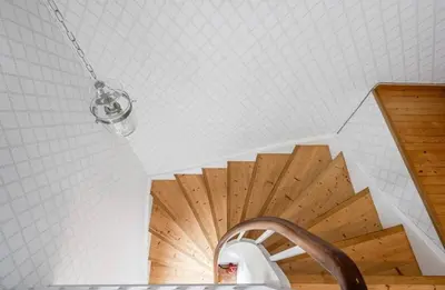 a bathroom with a staircase with a wooden ceiling at A Cozy Nordic Home in Ålset