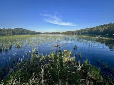 a view of a lake with a boat in the water at A Cozy Nordic Home in Ålset