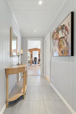 a hallway of a home with a table and a mirror at Luxury cabin with amazing views in Stryn