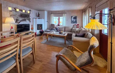 a living room with a couch and a table at Amazing Apartment In Edland With House Sea View in Nesland
