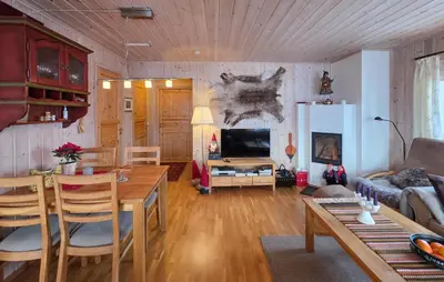 a living room with a table and a couch at Amazing Apartment In Edland With House Sea View in Nesland