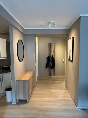 a room with a hallway with a mirror on the wall at Bright and modern city center apartment in Ålesund