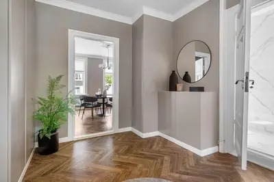 a hallway with a mirror and a dining room at Classic apartment with good standard in the city center in Trondheim