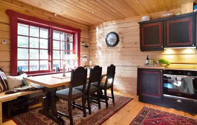 a dining room with a table and a clock on the wall at Amazing Apartment In Bjorli With Wifi in Bjorli
