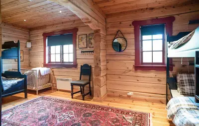 a log cabin with a bedroom and a bed and windows at Amazing Apartment In Bjorli With Wifi in Bjorli
