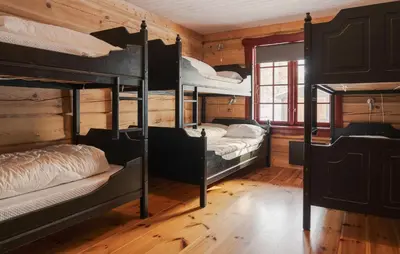 a room with four bunk beds in a cabin at Gorgeous Apartment In Bjorli With House A Panoramic View in Bjorli