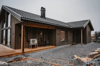 a house with a deck with a computer on it at Luxury cabin, Wellness and view over the Tyrifjord in Vikersund