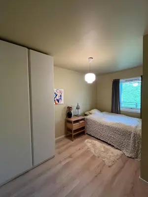a bedroom with a bed and a window at Newly renovated 3-room apartment in Bergen