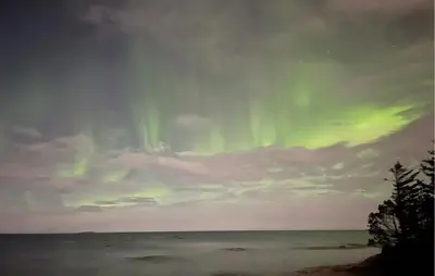 an image of the aurora in the sky over the ocean at Nice Home In Harøya With Harbor View in Steinshamn